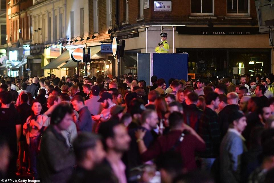 30403202-8490751-A_policeman_keeps_watch_over_the_large_crowds_that_gathered_on_t-a-6_1593930305822.jpg